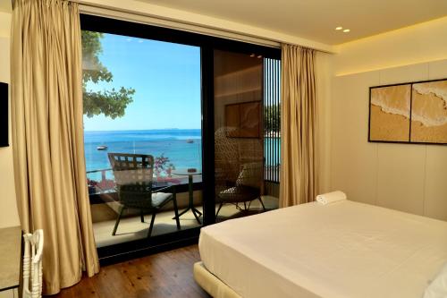 a bedroom with a bed and a view of the ocean at Manolo & Jolie Luxury Villa in Himare