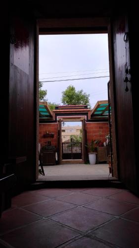 an open door to a building with a gate at 彼岸古厝民宿-包棟優先--Biiann B&B in Jinning