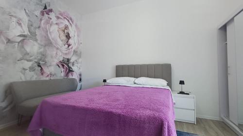 a bedroom with a bed with a purple blanket at Apartment house Nena in Krk