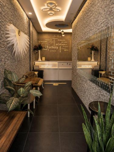 a restaurant with tables and plants in a room at Giray Hotel in Alanya