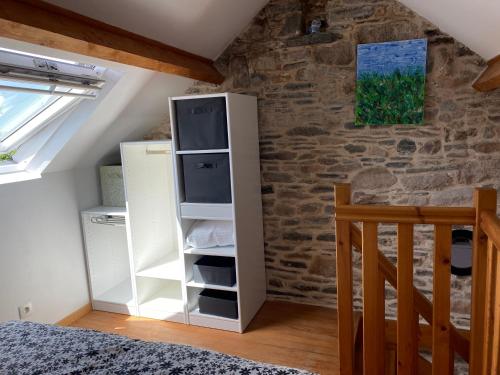 a room with a white cabinet in a attic at Gite du Becquet in Le Rozel