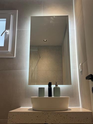 a bathroom with a sink and a mirror at Sofia Studios in Benitses