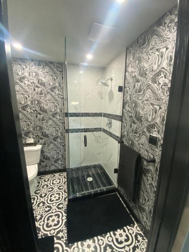 a bathroom with a shower with a glass door at The Station House in Brantford