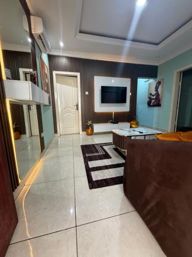 a living room with a couch and a television at Ivory Max in Ikeja