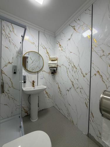 a bathroom with a sink and a mirror at Healing stay hostel in Dzuunmod