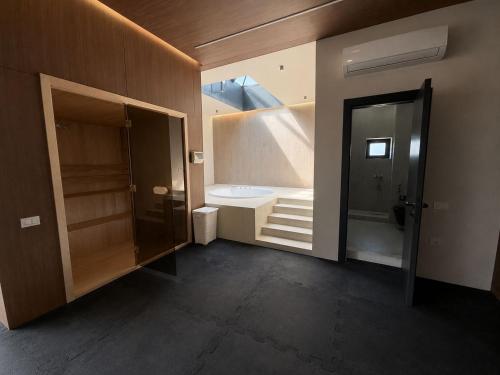 a bathroom with a door open to a room with a staircase at PoolSummerHouse in Baku