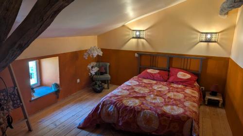 a bedroom with a bed and two lights on the wall at La demeure de vos désirs in Pressac