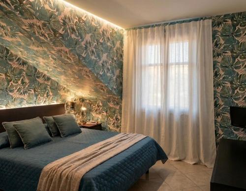a bedroom with a bed and a window at Azzurro Garda in Sirmione
