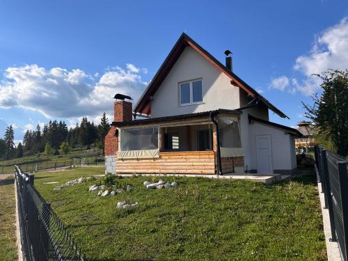 a house with a fence in front of it at Vikendica Nuhanović - Vlašić in Vlasic
