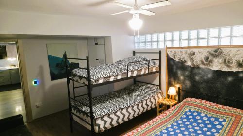 two bunk beds in a room with a ceiling at Elegant & Cozy Retreat Home, City Center Gem, At the Seaside, Steps from the Tram in Konak