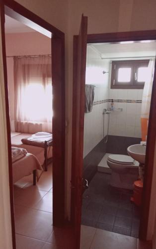 a bathroom with a toilet and a sink at Catherine Seaside Apartment in Ouranoupoli