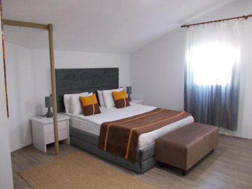 a bedroom with a large bed with orange pillows at Sorta Hotel in Antalya
