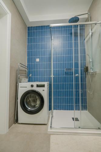 a washing machine in a bathroom with a shower at Vista Point Suites in Marsalforn