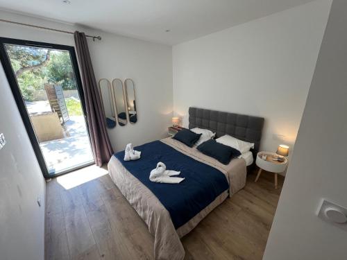 a bedroom with a large bed with swans on it at Aria Linda in Belgodère