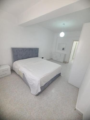 a white bedroom with a large white bed in it at SeaView 7 Floor -No Elevater in Durrës