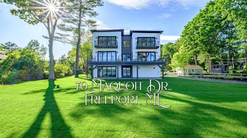 a house on a lawn with the words to network dvr report me at Modern Ocean Front Home 4 bed, 5 bath Freeport in Freeport