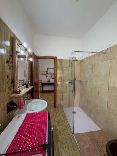 a bathroom with a tub and a sink and a shower at Budoni Casa Vacanze - MAR DEI CORALLI in Budoni