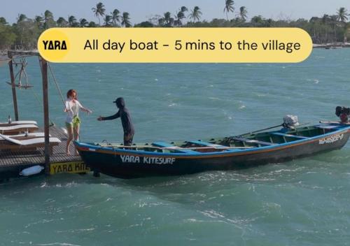 a boy and a girl standing on a boat in the water at Yara Floating Villa in Guriú