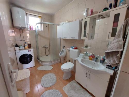 a bathroom with a toilet and a sink and a shower at Ariana Guest House in Prizren