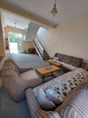 a living room with two couches and a table at Ariana Guest House in Prizren