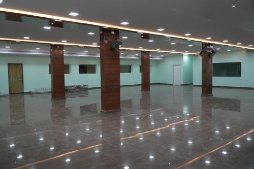 a large room with columns and a dance floor at Sri Laxmi Grand Convention in Tuni