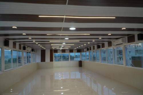 a large empty room with windows in a building at Sri Laxmi Grand Convention in Tuni