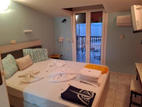 a bedroom with a bed with towels on it at attic sea view studio in karmiris studios in Zakynthos
