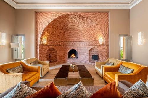 a living room with a fireplace and a brick wall at Luxury Palace in Marrakesh in Marrakesh