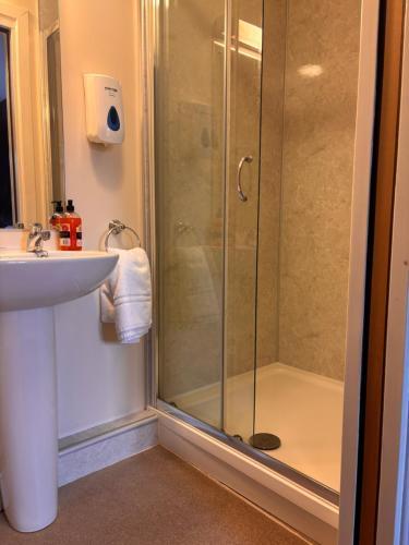 a bathroom with a shower and a sink at Kindrogan House in Straloch