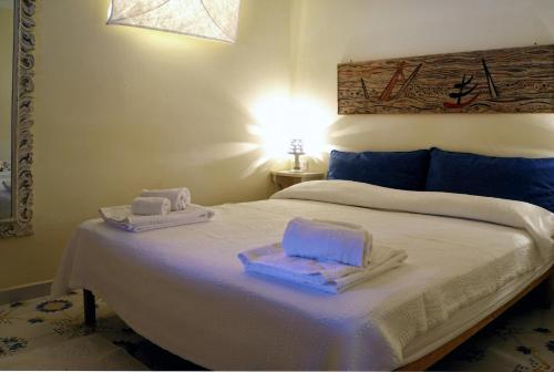 a bedroom with a bed with towels on it at Dammuso Vento Del Sud in Pantelleria