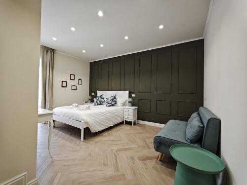 a bedroom with a bed and a couch at La Dimora delle Muse in Sulmona