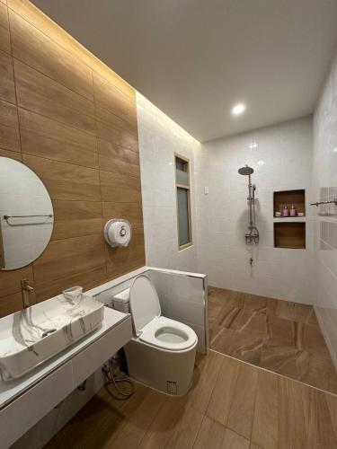 a bathroom with a toilet and a sink at Rimna Pool Villa in Hat Yai