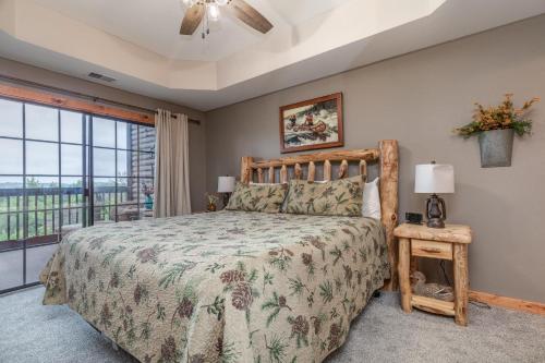 a bedroom with a bed and a large window at 2BR Village At Indian Point 501 near SDC-Free Tickets Daily up to $500 in Branson