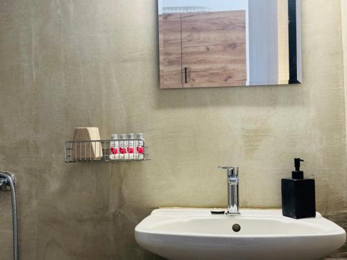 a bathroom with a white sink and a mirror at Faidrahouse in Alyki