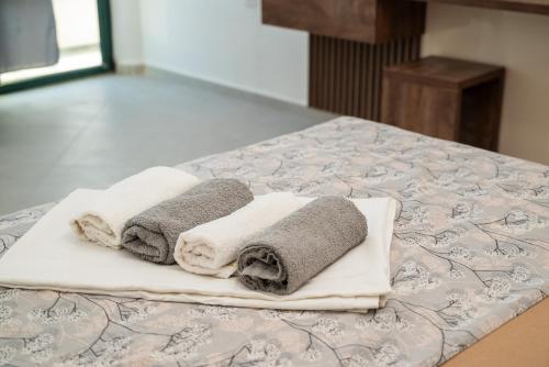 two towels sitting on top of a bed at Apartmens Aida Luks in Ulcinj