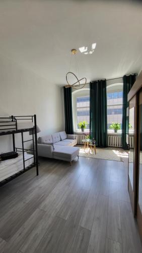 a living room with a couch and a bed at Old Town Apartment Opole in Opole