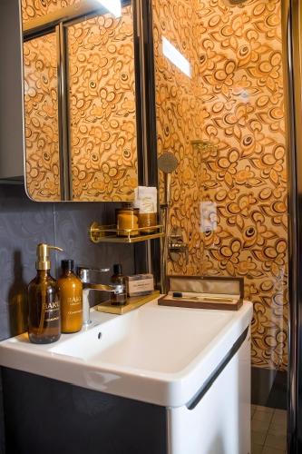 a bathroom with a sink and a mirror at The Moonlight Luxury Hotel in Baku