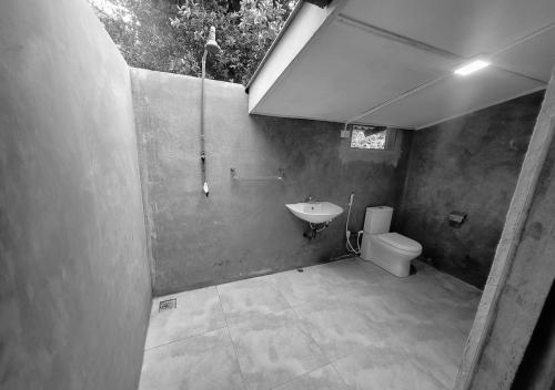 a bathroom with a sink and a toilet at Heritage Haven in Kandy