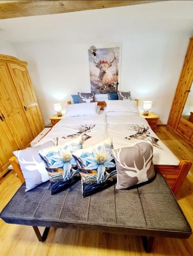a large bed with pillows on it in a room at Apartment Katzensilber in Rothenthurm