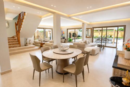 a living room with a table and chairs at Villa a cabonegro tetouan in Tétouan
