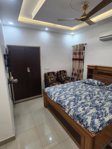 a bedroom with a bed and a ceiling fan at Private Duplex Stay with Open Terrace in Meerut