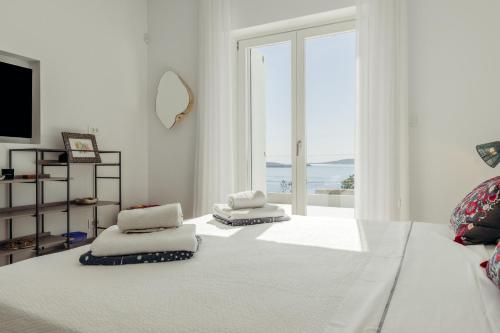 a white room with two pillows on the floor at Villa Paschalia,Sea View, Pool, Gym, Sleeps 10 in Mikonos