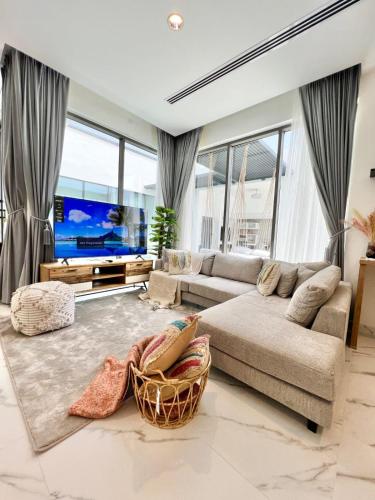 a living room with a couch and a flat screen tv at Rosella Chalet in Jabal Al Akhdar