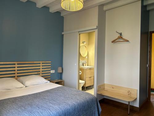 a bedroom with a bed and a sink and a mirror at Maison d'hôtes Le Rancher in Teloché