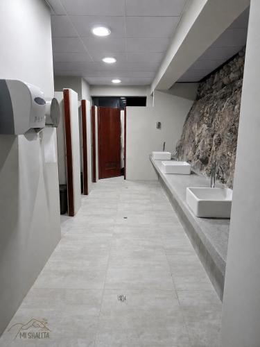 a bathroom with two sinks and two urinals at Mi Shalita in Santa Cruz