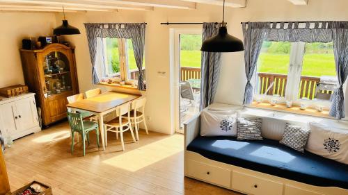 a room with a bed and a dining room with a table at Chata u Studnaře in Křivoklát