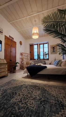 a bedroom with a large bed and a chandelier at Melita Living in Sliema