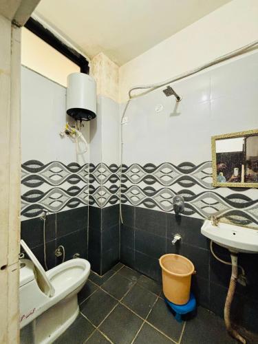 a bathroom with a sink and a toilet and a sink at Radha Krishna Hotel in Karauli