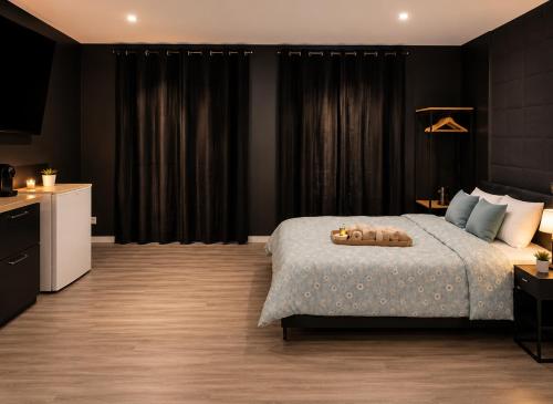 a bedroom with a large bed and black curtains at Suite Cinéma #7#- Jacuzzi in Roubaix