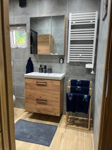 a bathroom with a sink and a mirror at Nest Haus in Ludwikowice Kłodzkie